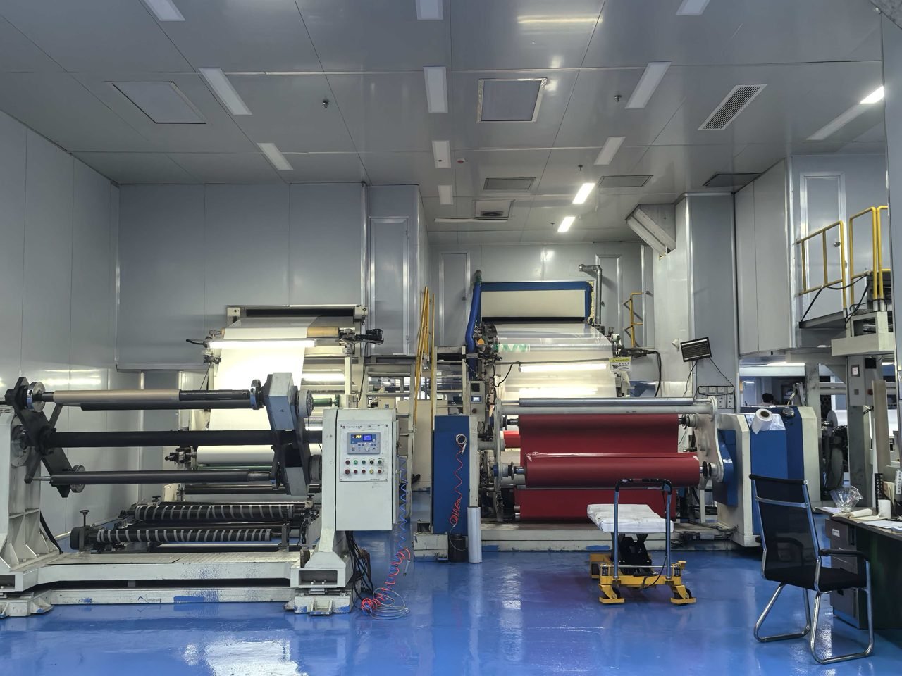 Roll processing machines with control panels, blue floor